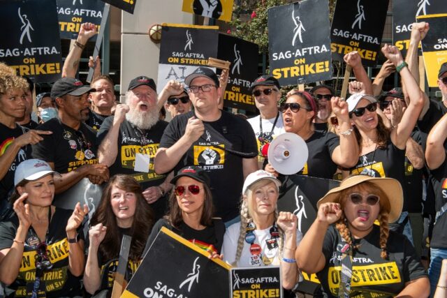 Some of the SAG-AFTRA negotiating committee address members at the picket line outside War