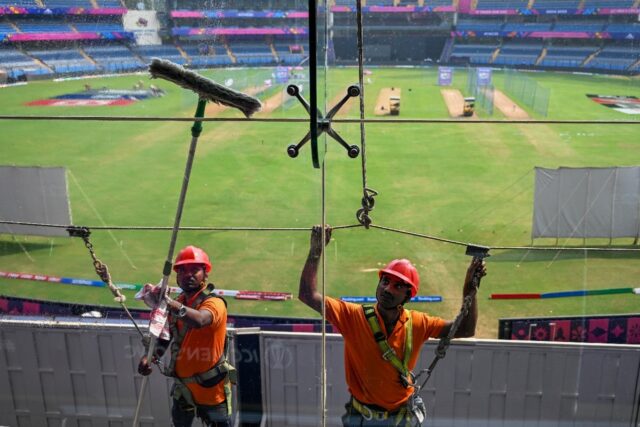 Point of view: Workers clean glass outside the media box at the Wankhede Stadium in Mumbai