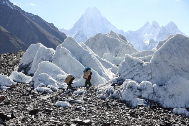 Pakistani porters hike the Baltoro Glacier, July 14, 2023