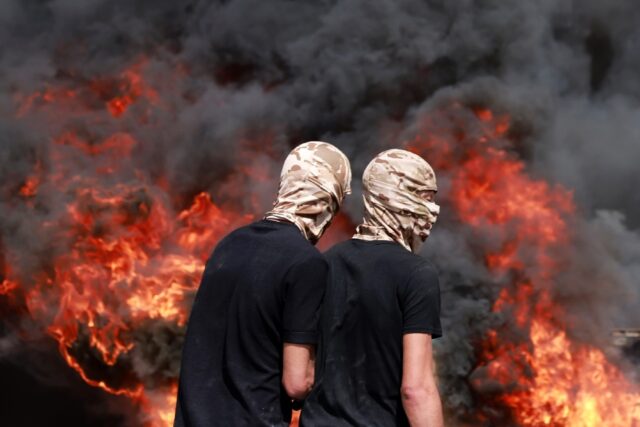 Palestinians burned tyres in clashes with Israeli security forces during Dmidi's funeral