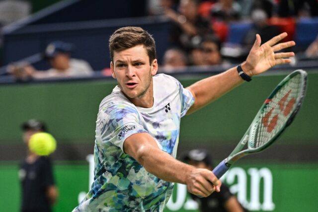 Poland's Hubert Hurkacz hits a return against Russia's Andrey Rublev
