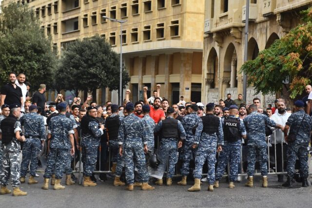 Police stop men from intercepting a march in support of liberties in Beirut