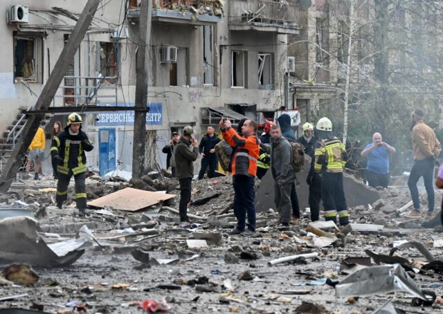 Rescue and emergency crews in Kharkiv after Russian missile strikes that left a boy killed