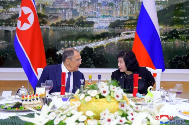 Russian Foreign Minister Sergei Lavrov (L) chats with North Korean counterpart Choe Son H