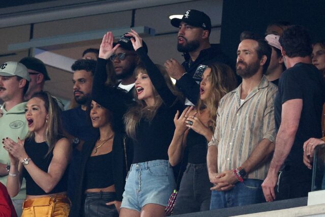 Singer Taylor Swift and actors Blake Lively and Ryan Reynolds cheer prior to the NFL game