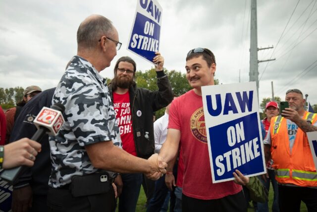 United Auto Workers President Shawn Fain greets UAW members as they strike the General Mot