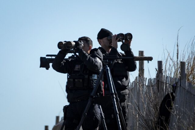 United States Secret Service counter-snipers and other security personnel keep watch as US