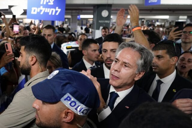 US Secretary of State Antony Blinken is applauded by people as he visits a donation center