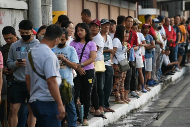 Voters queue to cast their ballots in the Philippines' village elections on Monday