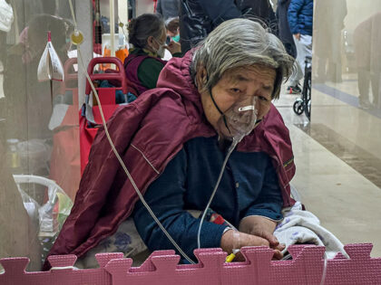 An elderly patient receives an intravenous drip while using a ventilator in the hallway of the emergency ward in Beijing, Jan. 5, 2023. China's sudden reopening after two years holding to a "zero-COVID" strategy left older people vulnerable and hospitals and pharmacies unprepared during the season when the virus spreads …