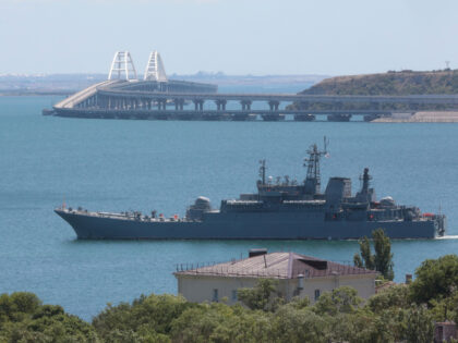 FILE - A Russian military landing ship, which now transports cars and people between Crime