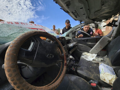 FILE - Palestinian medics inspect a damaged Ambulance hit by an Israeli air strike inside