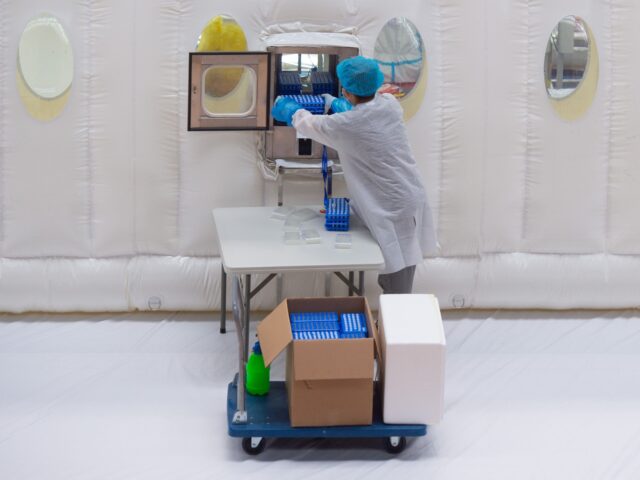 BEIJING, June 24, 2020 -- A staff member works in an inflatable COVID-19 testing lab in Be