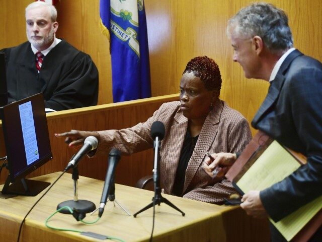 Bridgeport city employee Wanda Geter-Pataky, center, works with her lawyer, John R. Gulash