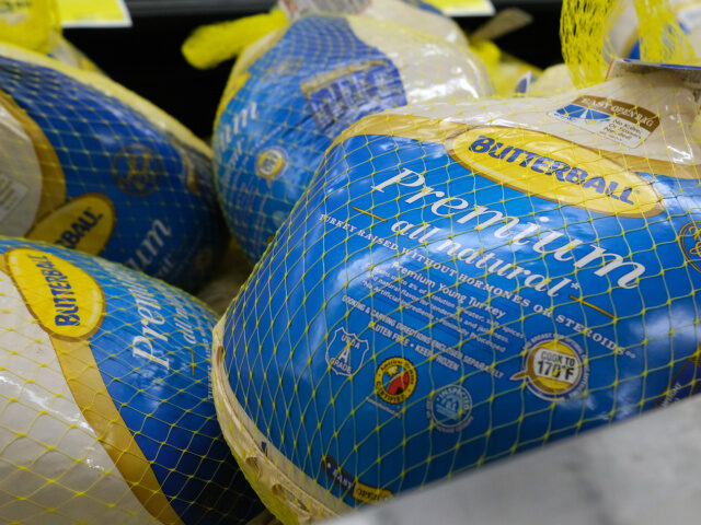 NEW YORK, NEW YORK - NOVEMBER 14: Frozen turkeys are displayed for sale inside a grocery s