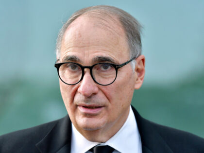 Political Strategist David Axelrod speaks to reporters as he arrives for the John F. Kenne
