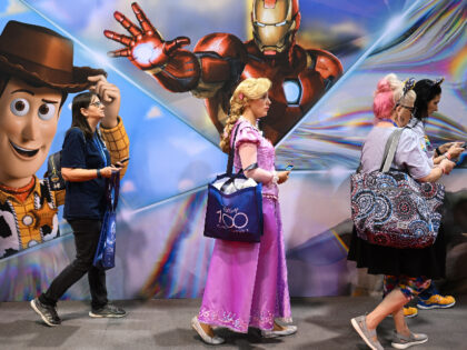 Fans wait in line to visit the D23 Expo Marketplace to buy merchandise during the Walt Dis