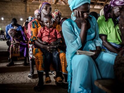 A Christian Adara boy prays along with his mother while attending the Sunday's service at Ecwa Church, Kajuru, Kaduna State, Nigeria, on April 14, 2019. The ongoing strife between Muslim herders and Christian farmers, which claimed nearly 2,000 lives in 2018 and displaced hundreds of thousands of others, is a …
