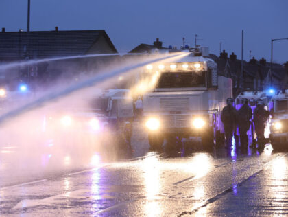 The PSNI use a water cannon on the Springfield road, during further unrest in Belfast. Pic