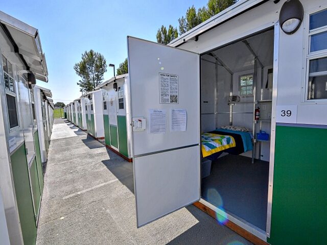 A view of housing units at the Tarzana Tiny Home Village which offers temporary housing for homeless people, is seen onJuly 9, 2021 in the Tarzana neighborhood of Los Angeles, California. - The habitats are very small prefabricated houses, installed in a parking lot in Los Angeles. The 