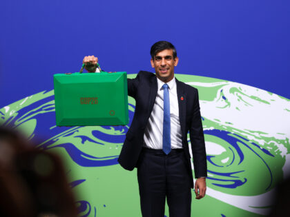Rishi Sunak, U.K. chancellor of the exchequer, holds a COP26 Green despatch box during the COP26 climate talks in Glasgow, U.K., on Wednesday, Nov. 3, 2021. Climate negotiators at the COP26 summit were banking on the worlds most powerful leaders to give them a boost before they embark on two …
