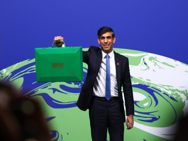 Rishi Sunak, U.K. chancellor of the exchequer, holds a COP26 Green despatch box during the