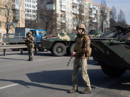 KYIV, UKRAINE - FEBRUARY 25: Ukrainian servicemen stand on patrol at a security checkpoint