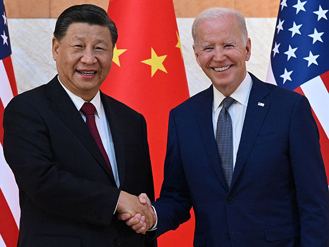 US President Joe Biden (R) and China's President Xi Jinping (L) shake hands as they meet o