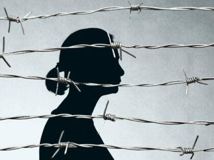 Woman Prisoner Behind Barbed Wire