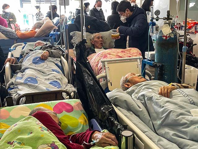 Patients on stretchers are seen at Tongren hospital in Shanghai on January 3, 2023. - A se