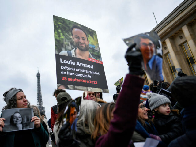 Demonstrators hold portraits of French detainees in Iran Cecile Kohler (L) and Louis Arnau