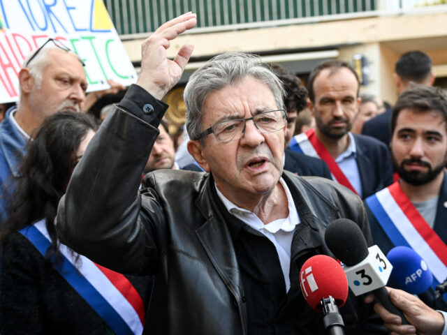 Former leader of the leftist "La France Insoumise" (LFI) party Jean-Luc Melenchon talks to