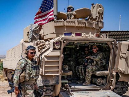 US soldiers patrol the countryside of Rumaylan (Rmeilan) in Syria's northeastern Hasa