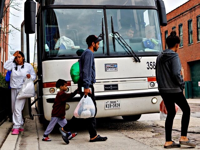 A group of migrants exit a bus near a Greyhound station in Chicago after being transported from Texas on Sept. 27, 2023. Over 15,000 migrants have been transported to Chicago since last year.
