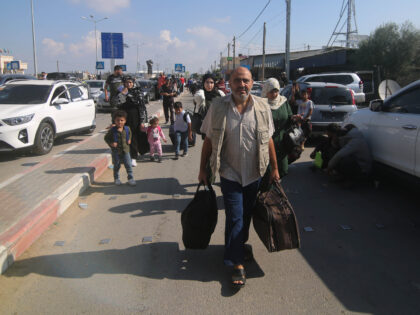 People arrive at the Rafah border crossing in the southern Gaza Strip city of Rafah, on Oc