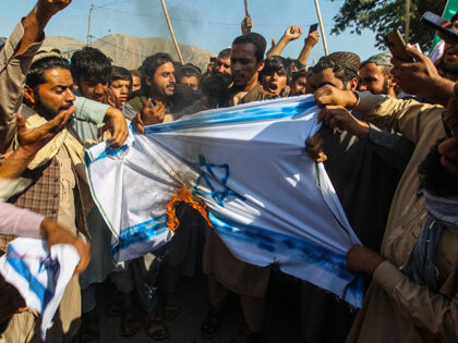 Afghan protesters burn a flag of Israel during an anti-Israel demonstration in Ghani Khel
