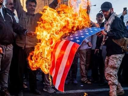 People burn the Flag of the United States during a demonstration in support of Palestine in Tehran, Iran, on October 18, 2023 (Photo by Hamid Vakili/NurPhoto via Getty Images)