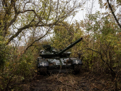 KHARKIV REGION, UKRAINE - OCTOBER 20. A T-64BV tank is parked under trees near a base a fe