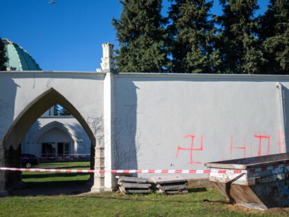 This photo taken on November 1, 2023 shows swastika symbols sprayed on an external wall in front of the ceremony hall at the Jewish part of the Central Cemetery in Vienna, Austria, after police cordoned off the area. Austrian police on November 1 were investigating a fire that damaged a …