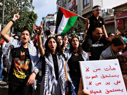 Palestinians chant slogans in support of the people in the Gaza Strip amid ongoing battles