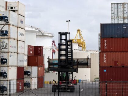 A worker moves containers at the compound of ports operator DP World at Port Botany in Syd