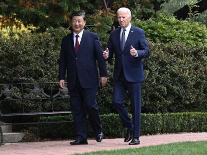 TOPSHOT - US President Joe Biden (R) and Chinese President Xi Jinping walk together after