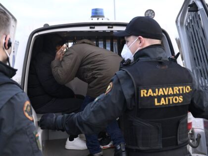Border guards place asylum seekers that had crossed over from Russia into a van to be transported to a reception centre from the Nuijamaa border station between Russia and Finland in Lappeenranta, south eastern Finland early morning on November 16, 2023. Russia said it "deeply regretted" Finland's move to consider …