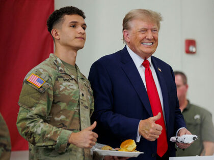 Former President Donald Trump poses for a photo with a service member at the South Texas International airport on November 19, 2023 in Edinburg, Texas. Trump and Texas Governor Greg Abbott served meals to Texas National Guard and Texas DPS Troopers that are stationed at the U.S.-Mexico border over the …