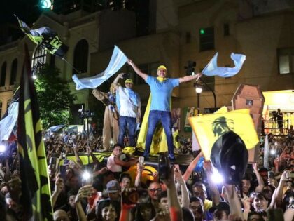 Supporters of the Argentine presidential candidate for the La Libertad Avanza alliance, Javier Milei, celebrate his victory in the presidential election runoff outside the party headquarters in Buenos Aires on November 19, 2023. Libertarian outsider Javier Milei pulled off a massive upset Sunday with a resounding win in Argentina's presidential …