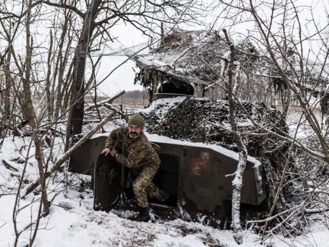 KHARKIV OBLAST, UKRAINE - NOVEMBER 20: Ukrainian soldier exits an artillery vehicle at his