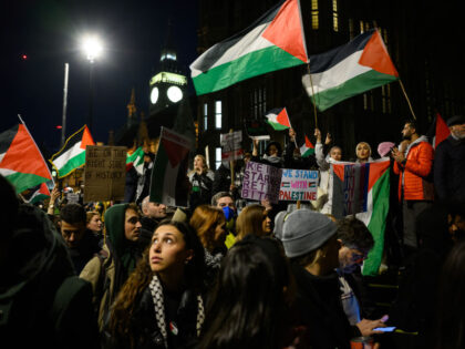 LONDON, ENGLAND - NOVEMBER 15: Protestors chant and wave flags as they call for the Government to back a vote on a ceasefire in Israel, during a demonstration at Parliament Square on November 15, 2023 in London, England. Parliamentarians are poised to vote on an SNP motion urging a ceasefire …