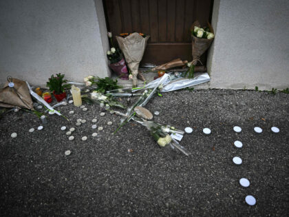 A photograph shows bunches of flowers and candles displayed in front of the reception hall in Crepol, southeastern France on November 22, 2023, where Thomas, a teenager, passed away on November 19, 2023 after being wounded with a knife during a ball in the small village in the Drome region. …