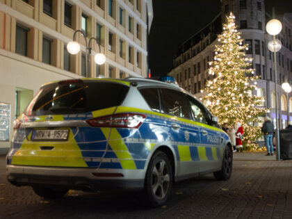 A general view of a police car parked in front of a Christmas tree at the city center in Cologne, Germany, on November 23, 2023, during the opening day of Cologne's traditional Christmas market. (Photo by Ying Tang/NurPhoto via Getty Images)