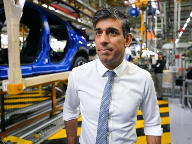 Britain's Prime Minister Rishi Sunak reacts during a visit to the Nissan production p